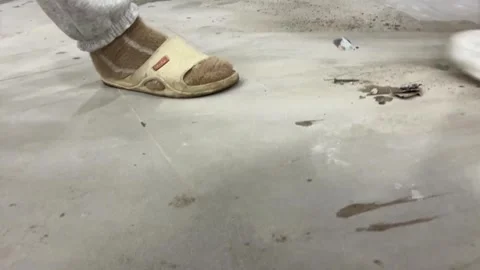 Sweeping construction debris with a yellow broom 库存影片 264603601