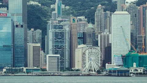 A sweeping continuous shot captures Hong Kong’s dense urban landscape with Stock Footage 338310981