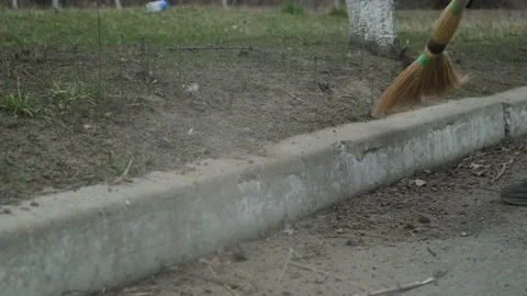 Sweeping the curb with a broom Stock Footage 191021620