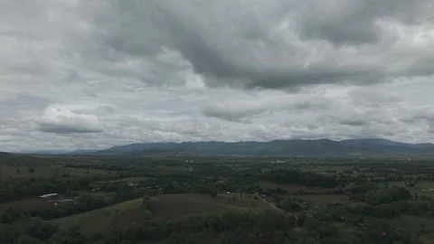 Sweeping Dark Aerial View of Rolling Hills, Farm Barn and Layered Mountains.. Stock Footage 337392298