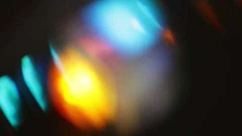 Sweeping diagonal bokeh bands with rainbow prism glow on a black background.. Stock Footage 341736881