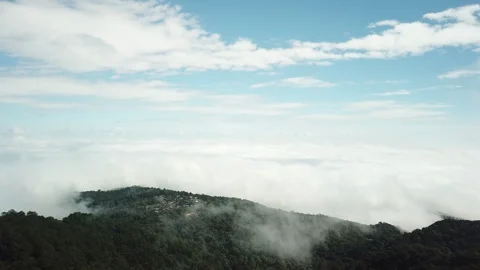 Sweeping Drone Shot of Mist Rolling Through Tropical Mountain Valley Stock-Footage 333696778