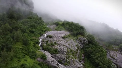Sweeping Drone View of mountain, waterfall, fog, trees and cloud in norway Video stock 292788333