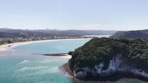 Sweeping drone view over Whangamatā Beach, with its broad sandy shoreline Stock Footage 341554440
