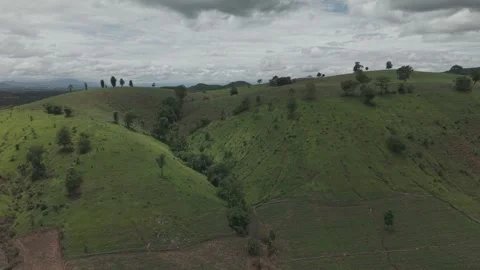 Sweeping Drone View of Tropical Green Hills, Earthy Slopes and Overcast Rai.. Stock Footage 337390894