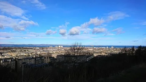 Sweeping elevated view of the historic Edinburgh cityscape and Firth of Forth Stock Photos