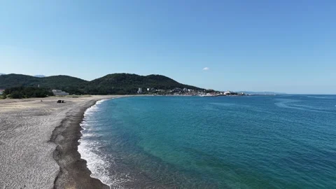 Sweeping Empty Pebble Beach and Clear Blue Sea on Korean Coast Stock Footage 344778485