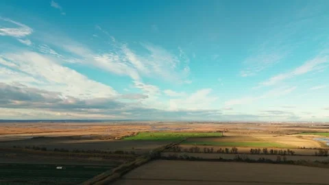 Sweeping fields beneath a vast sky Stock Footage 258774277