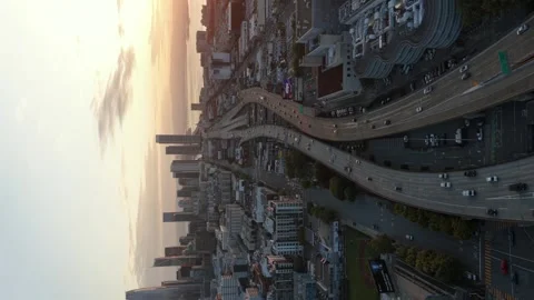 Sweeping freeway interchange with heavy traffic, FedEx truck, dense downtown Stock Footage 336270748