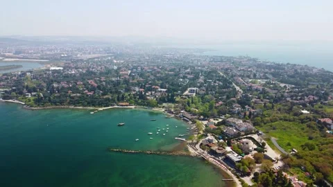 Sweeping high-angle aerial drone footage of a modern city's waterfront along the Stock Footage 323324334