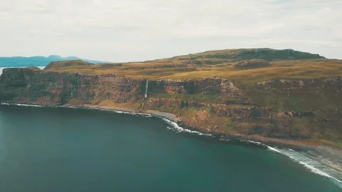 Sweeping landscape meeting the ocean split in half by a waterfall - Drone 4K 動画素材 113743059