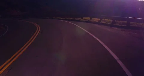 Sweeping motion view of empty winding road in the mountains Stock Footage 136337808