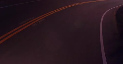 Sweeping motion view of empty winding road in the mountains Stock Footage 136337852