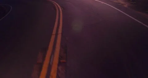 Sweeping motion view of empty winding road in the mountains Stock Footage 136337855