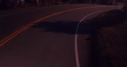 Sweeping motion view of empty winding road in the mountains Stock Footage 136337882