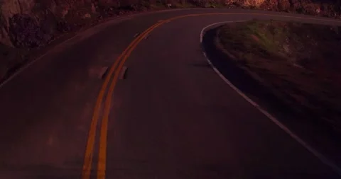 Sweeping motion view of empty winding road in the mountains Stock Footage 136337909