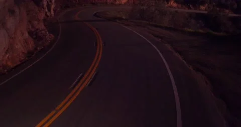 Sweeping motion view of empty winding road in the mountains Stock Footage 136337910