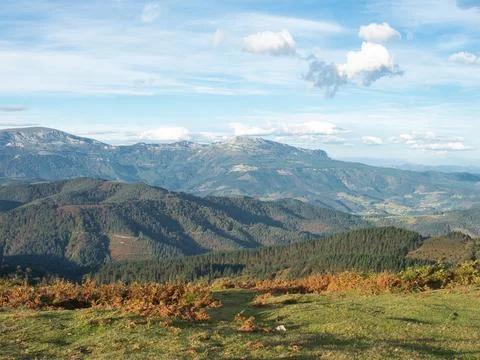 Sweeping mountain range view under a blue sky - A wide-angle landscape of m.. Stock Photos