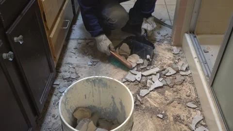 Sweeping up old tile and debris on a construcion job Stock Footage 300224212
