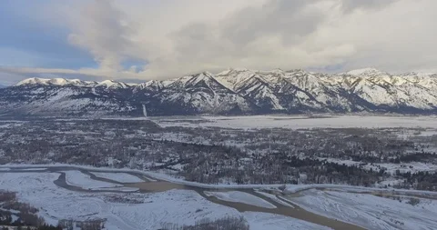 Sweeping Panoramic Mountain Light Sun Catching Snow Covered Peaks River Valley Video stock 87232682