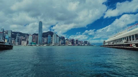 A sweeping panoramic view of Hong Kong's iconic skyline from a water-based Stock Footage 338310979