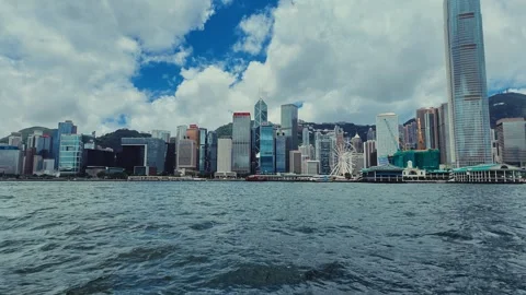 A sweeping panoramic view of Hong Kong's skyline from a water-based vantage Stock Footage 338311024