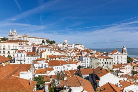 A sweeping panoramic view of Lisbon's iconic terracotta rooftops, white build Stock Photos