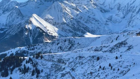 A sweeping panoramic view of the snow-covered slopes and rugged peaks of the Stock Footage 346688949