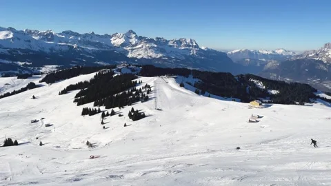 A sweeping panoramic view of a snowy ski slope in Megeve, located in the French Stock Footage 346690131