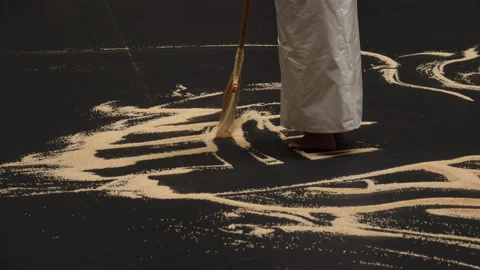 Sweeping patterns as part of an art performance. Medium close up broom. Video stock 203839553