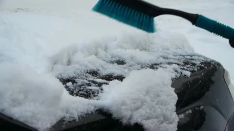 Sweeping snow away from a car Stock Footage