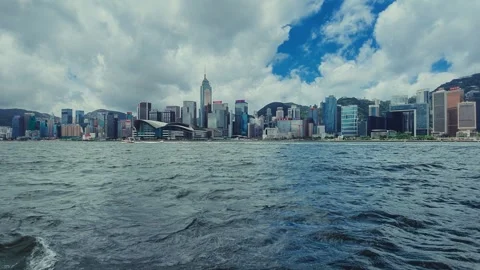 A sweeping view from a boat captures the Hong Kong skyline's modern architecture Stock Footage 338311021