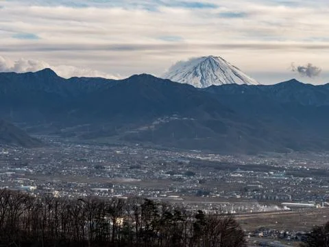 Sweeping views of a small Japanese town surrounded by mountains Stock Photos