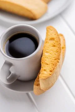 Sweet anicini cookies and coffee cup. Italian biscotti with anise flavor on w Stock Photos