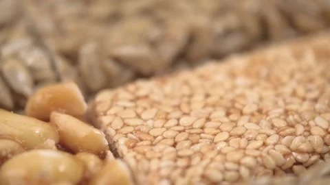 Sweet bars made sesame, peanuts and sunflower seeds in caramel closeup. rotation Stock Footage 249086793