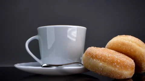 Sweet big donuts lie near a cup of coffee Stock Footage 126557053