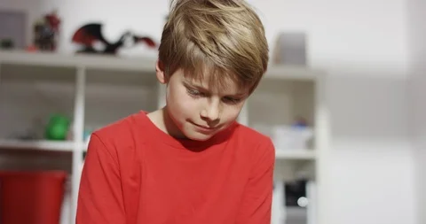 Sweet boy looking down playing on smartphone Stock Footage 101749912