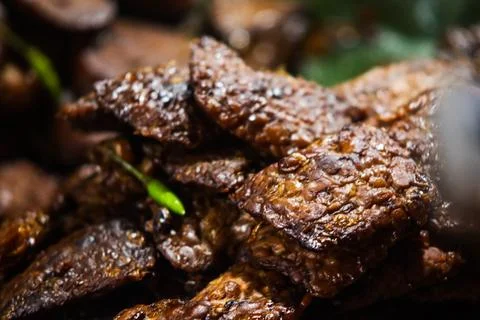 Sweet braised tempeh bacem stack with green cayenne pepper garnish closeup vi Stock Photos