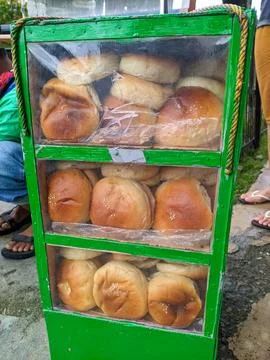 Sweet bread snacks are transported in a green bread storage container Stock Photos