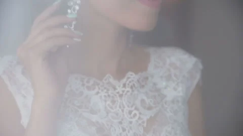 Sweet bride with a beautiful hair pulls on the earring. Stock Footage 87748845
