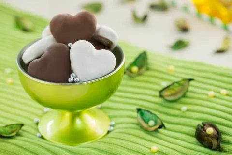 Sweet Brown and White Honey Hearts in Green Glass Stock Photos