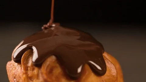 Sweet Cake is flowing with melted chocolate slow motion Macro Stock Footage 102620563