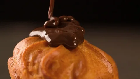 Sweet Cake is flowing with melted chocolate slow motion Close up Stock Footage 102620571