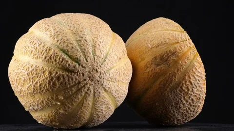 Sweet cantaloupe rotating, (loopable) on black background. Stock Footage 113678685