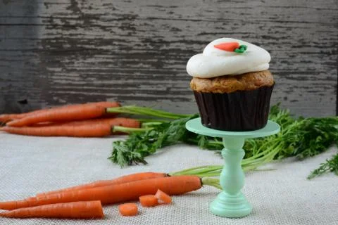 Sweet carrot cupcake with rustic background Stock Photos