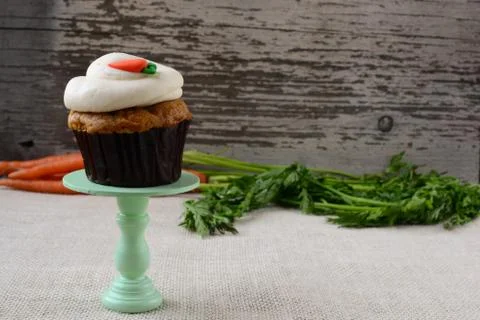 Sweet carrot cupcake with rustic background Stock Photos