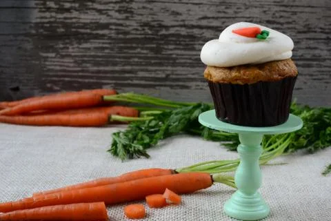 Sweet carrot cupcake with rustic background Stock Photos