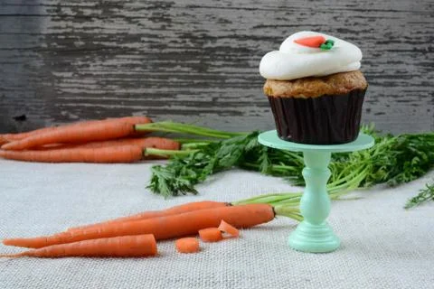 Sweet carrot cupcake with rustic background Stock Photos