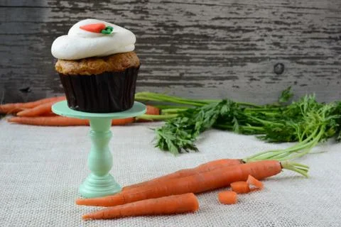 Sweet carrot cupcake with rustic background Stock Photos