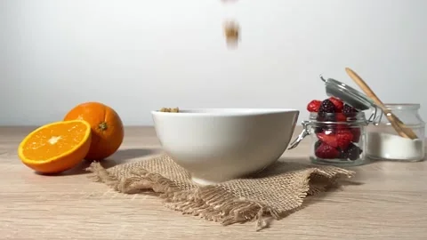 Sweet cereal chocolate pillows falling into bowl in slow motion. Stock Footage 130350026